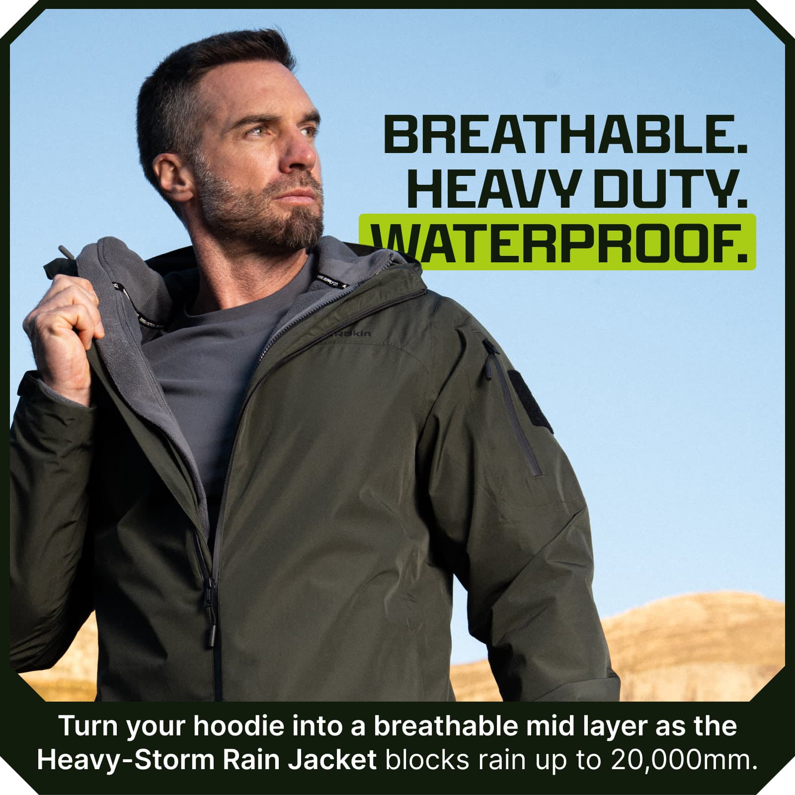 Man wearing olive green waterproof rain jacket with hood, zippered chest pocket, and fleece-lined collar outdoors